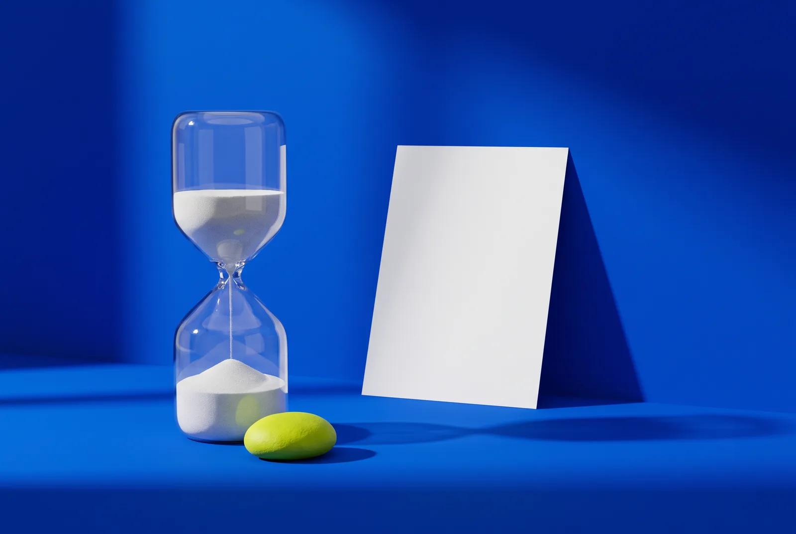 An hourglass beside a plain white card on cobalt blue, a nod to the question of whether QR codes ever expire.