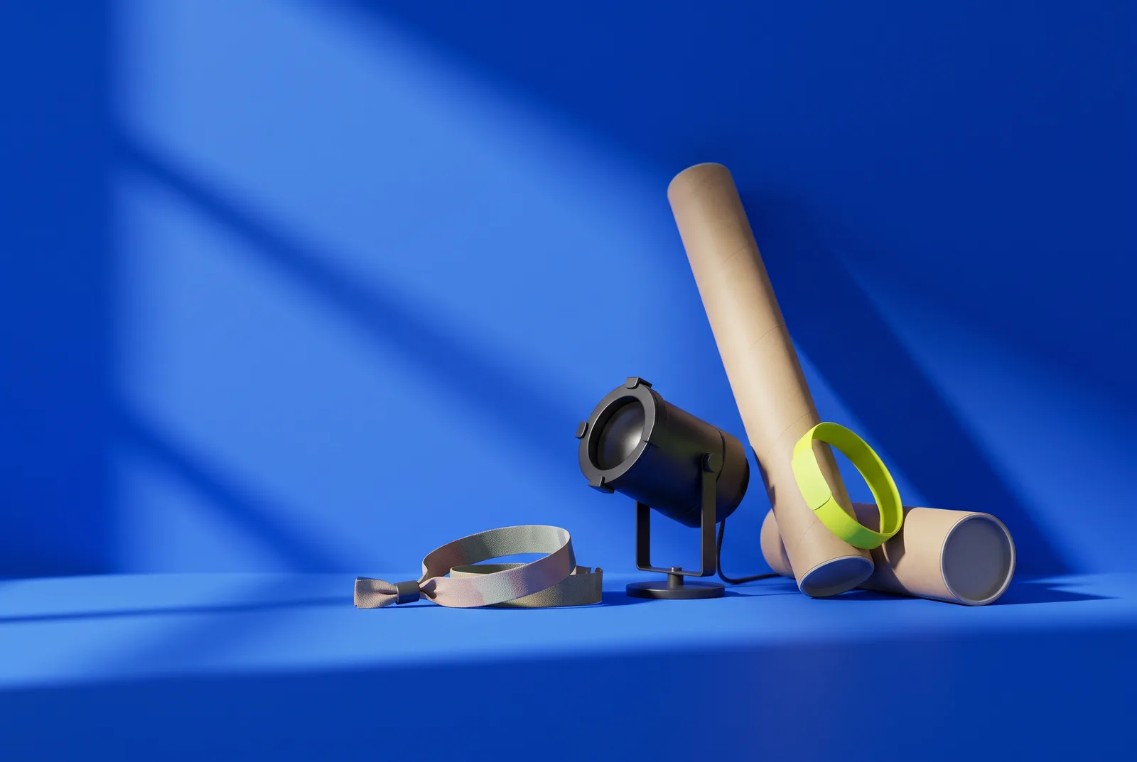 A fabric festival wristband, a small stage spotlight and a poster tube with a lime wristband, the kit behind a festival QR code campaign.