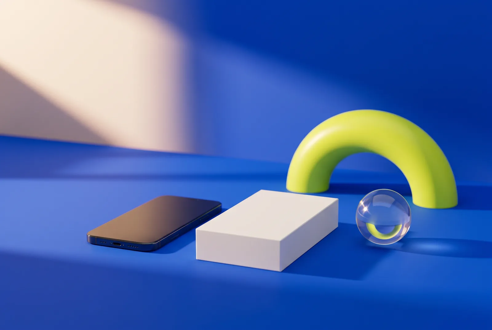 The future of QR codes: a smartphone lying face down, a plain white product box, a glass sphere and a lime arch like a rising sun on a cobalt blue stage.