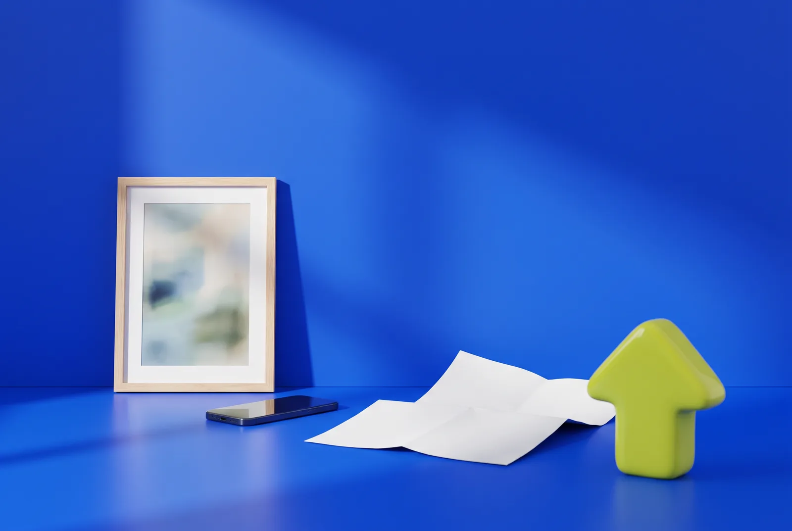 QR code trends: a framed abstract art print, a smartphone, a folded poster and a lime arrow sculpture pointing upward on a cobalt blue stage.