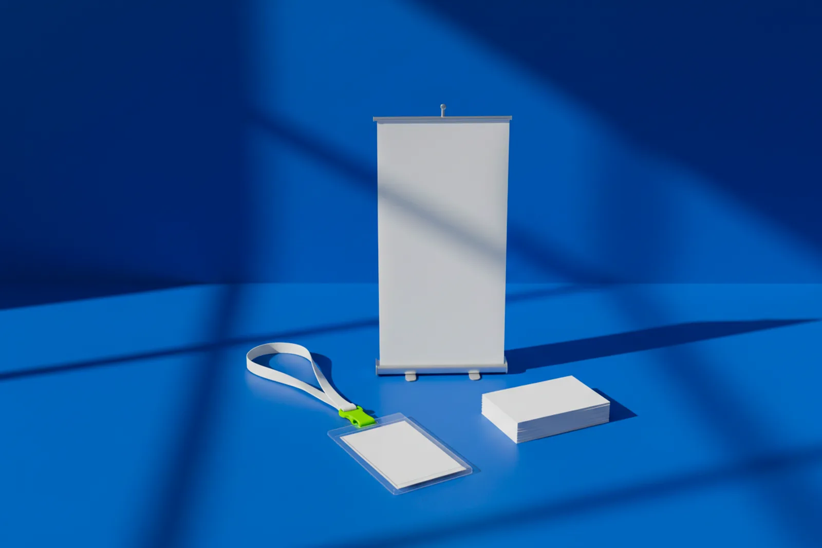 A blank conference badge on a lanyard, a stack of blank business cards and a small roll-up banner, the kit for trade show QR codes.