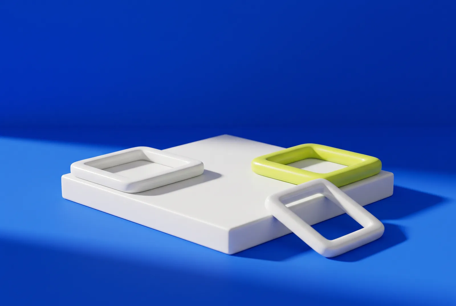 Three square frames on a white plinth against cobalt blue, one in lime, a nod to why QR codes have three squares in the corners.