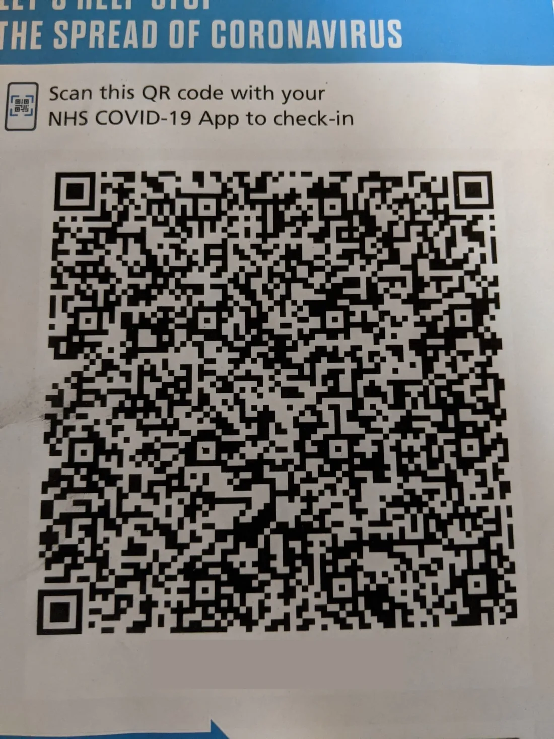 An NHS COVID-19 venue poster with a large QR code and the words Scan this QR code with your NHS COVID-19 app to check in.